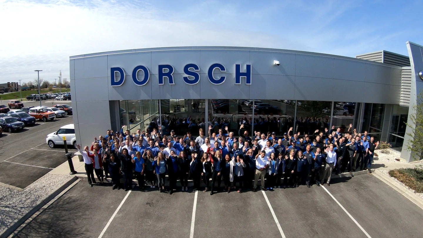A team of Dorsch is stands front of Dorsch building