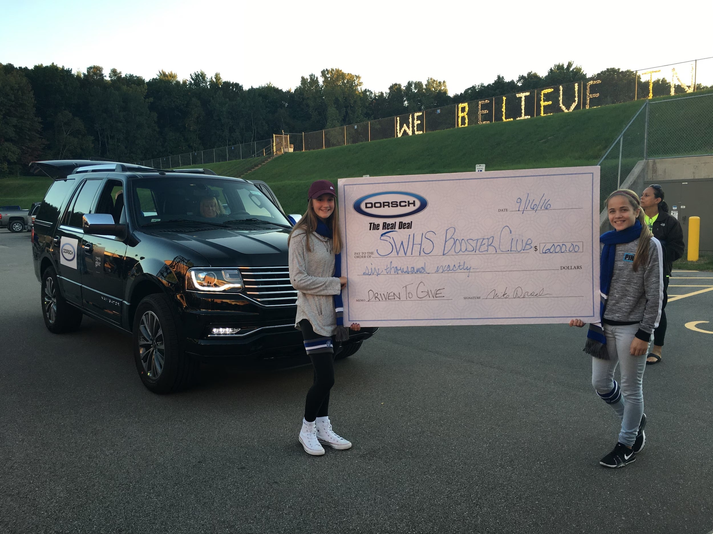 Southwest students prepare to walk in the Homecoming parade with a cheque for $6,000
