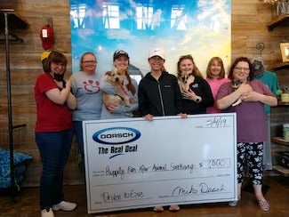 Happily Ever After Animal Sanctuary volunteers and animals available for adoption are gifted a cheque for $7,000!