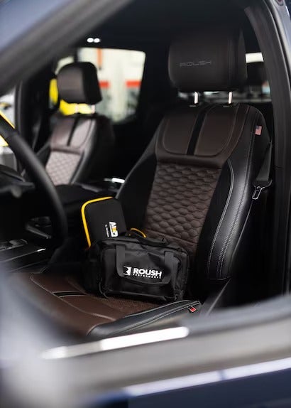 A close-up of a vehicle interior with a Roush branded bag