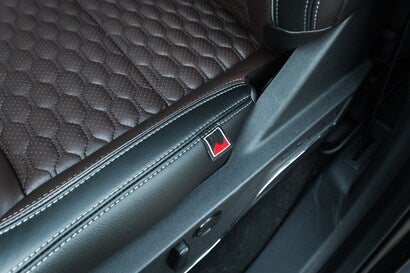 close-up of a vehicle's interior with black quilted upholstery.