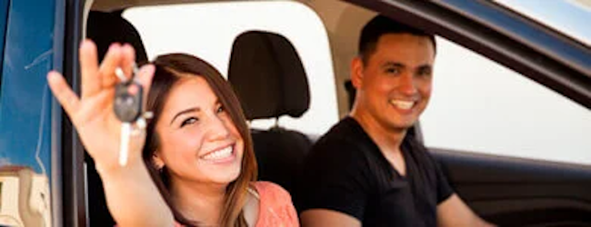 Happy customers in their new car.